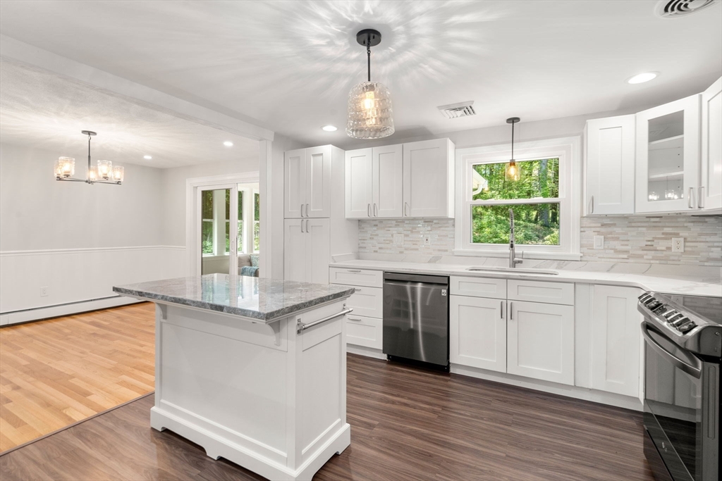 98 Union Street Norfolk, MA 02056 - Photo 12 of 38 a kitchen with stainless steel appliances granite countertop a sink a stove and a wooden floors
