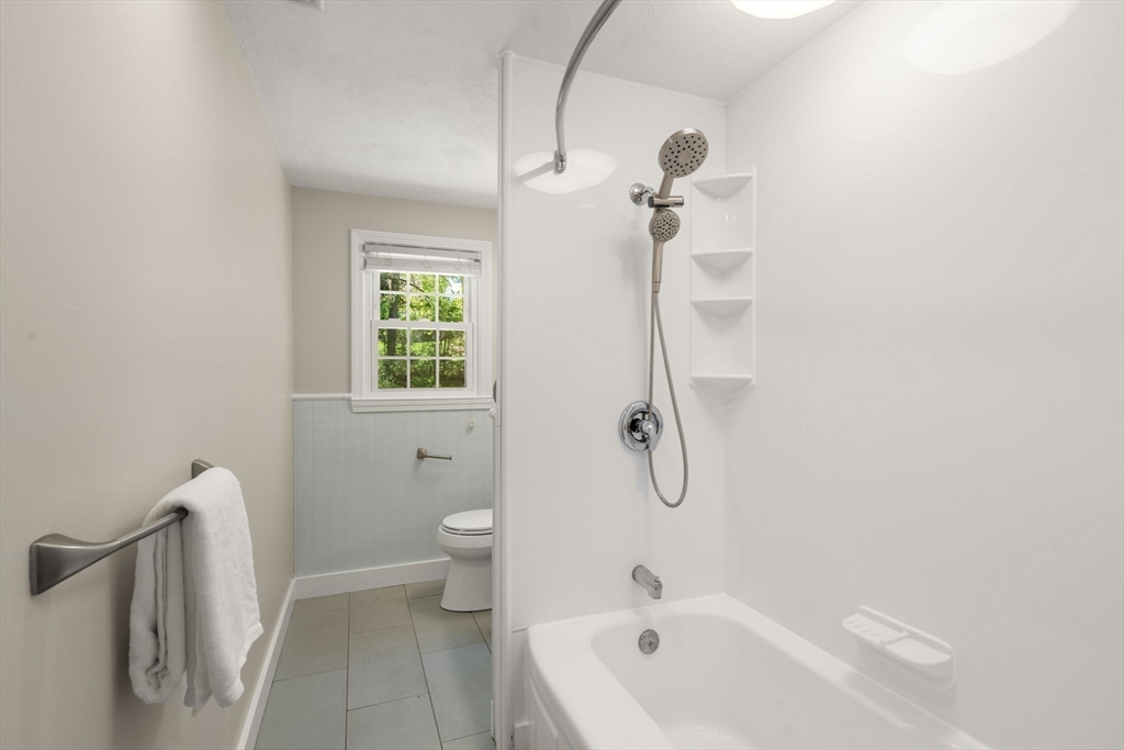 98 Union Street Norfolk, MA 02056 - Photo 17 of 38 a bathroom with a bathtub a toilet and a shower
