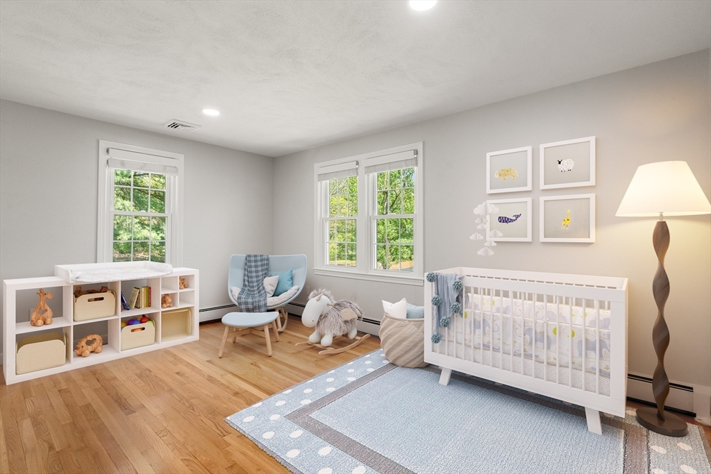 98 Union Street Norfolk, MA 02056 - Photo 21 of 38 a living room with a baby crib furniture a baby crib and a window