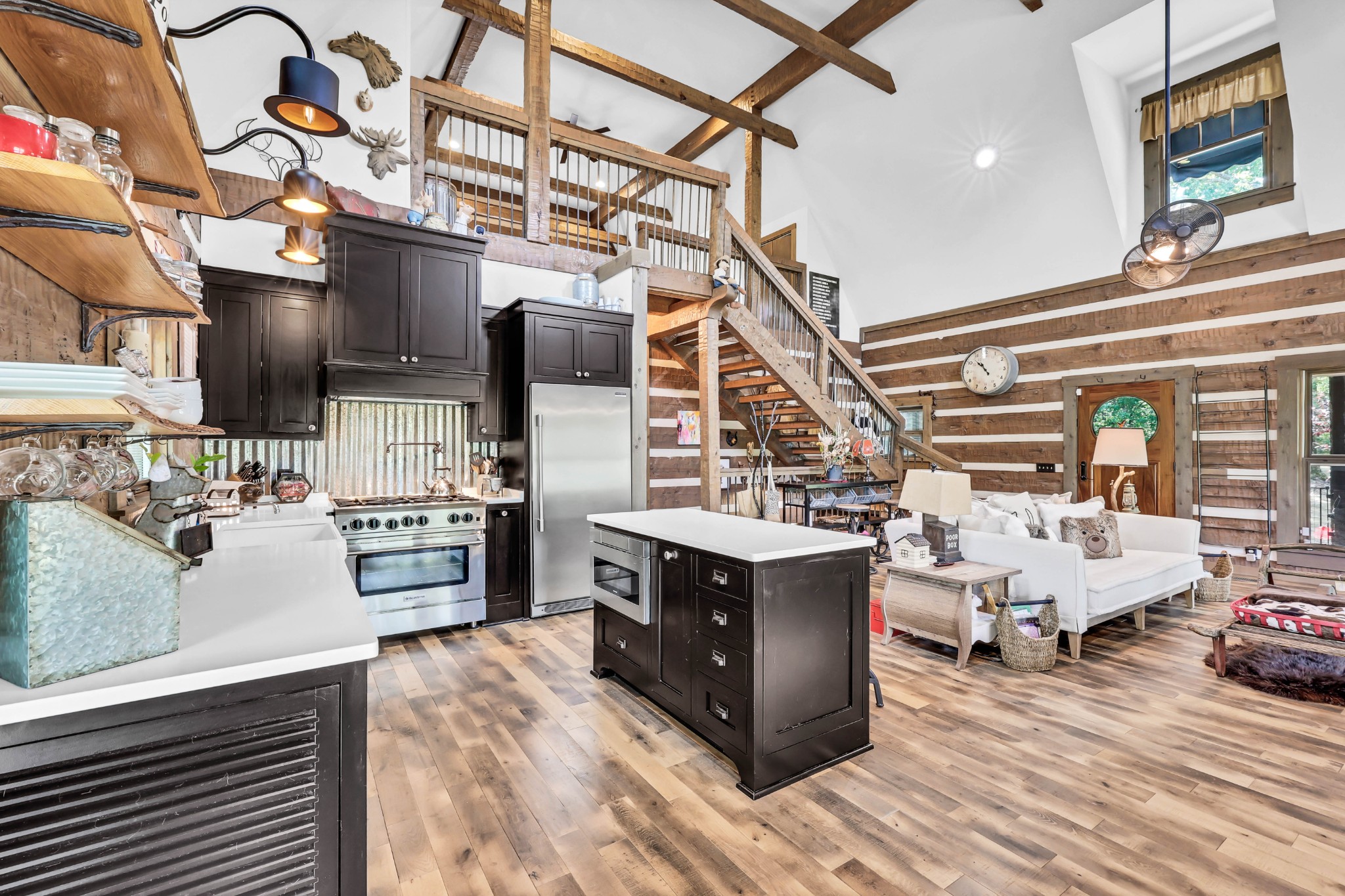 a kitchen with stainless steel appliances kitchen island granite countertop a sink and cabinets