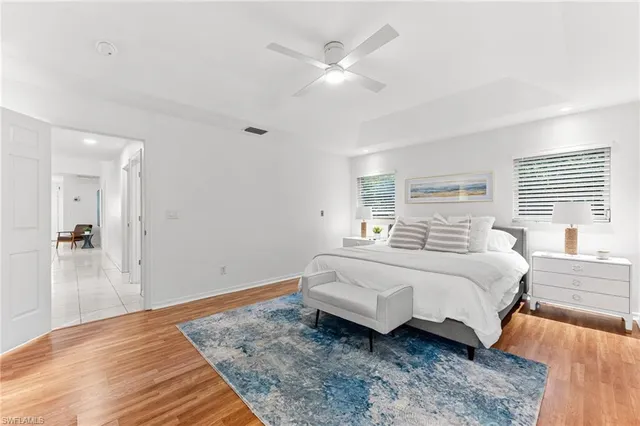 a spacious bedroom with a bed and a large window