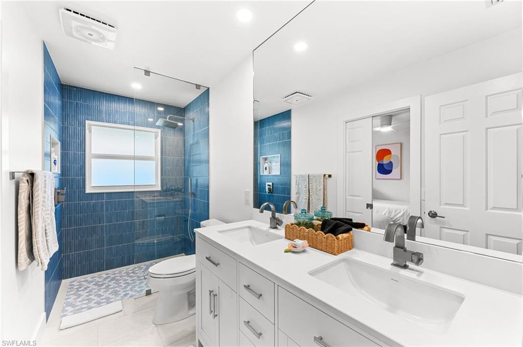 690 100th Avenue North Naples, FL 34108 - Photo 20 of 33 a bathroom with a sink a toilet and shower