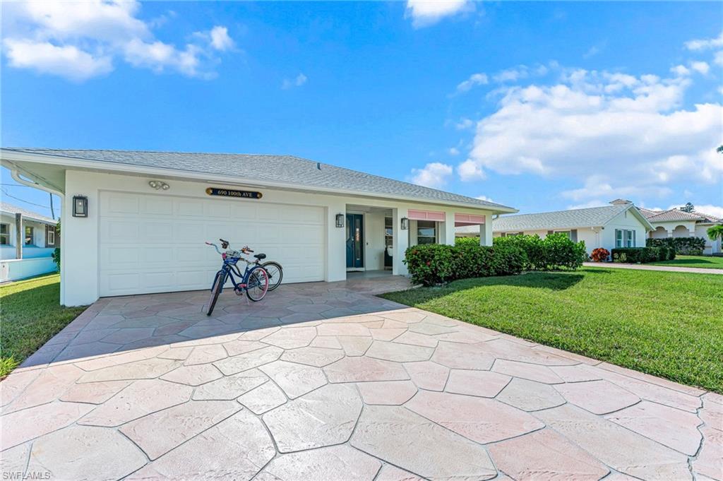 690 100th Avenue North Naples, FL 34108 - Photo 2 of 33 a view of a backyard and a garage