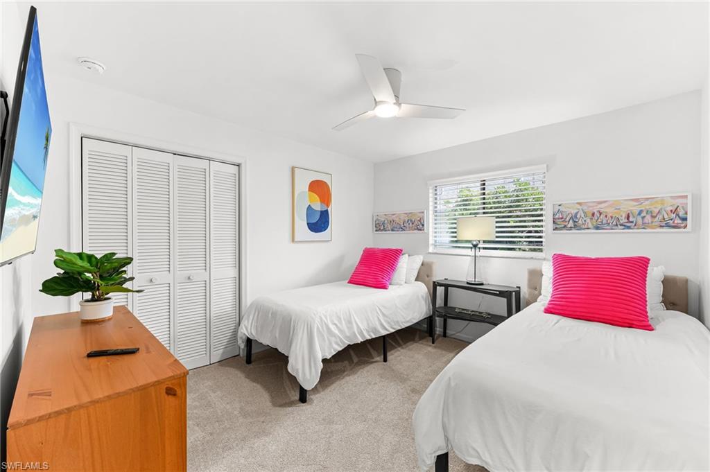 690 100th Avenue North Naples, FL 34108 - Photo 21 of 33 a bedroom with two beds and potted plant