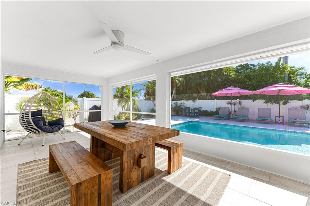 690 100th Avenue North Naples, FL 34108 - Photo 25 of 33 a view of a dining room with furniture and chandelier