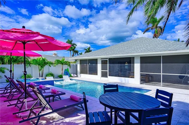 a view of a house with a yard and sitting area