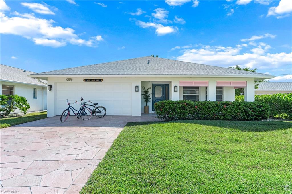 690 100th Avenue North Naples, FL 34108 - Photo 29 of 33 a front view of a house with a yard
