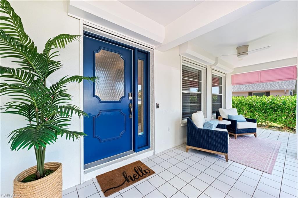 690 100th Avenue North Naples, FL 34108 - Photo 3 of 33 a living room with furniture and a potted plant