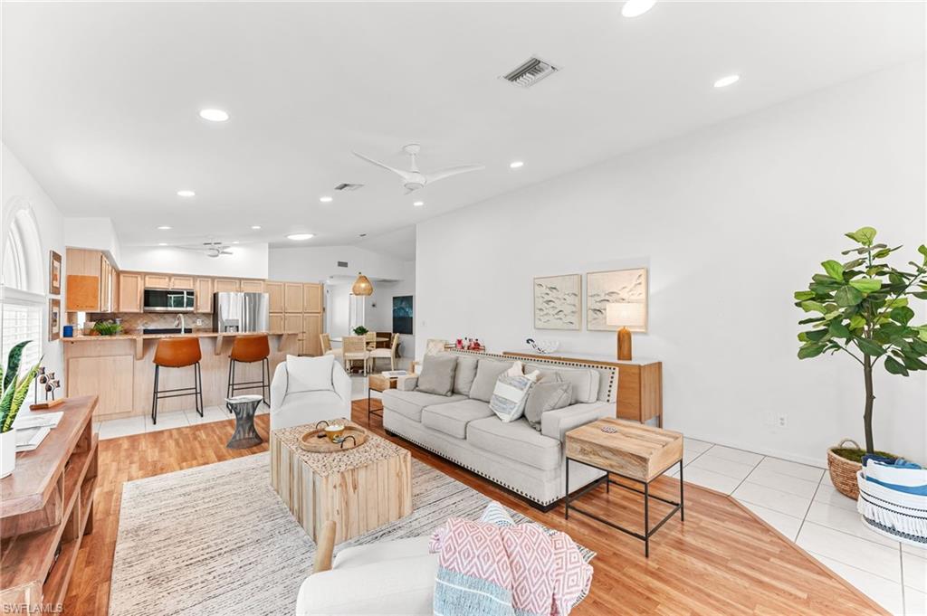 690 100th Avenue North Naples, FL 34108 - Photo 7 of 33 a living room with furniture kitchen view and a potted plant