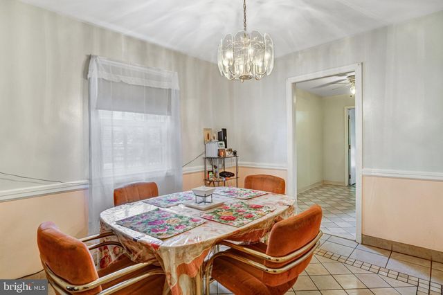 a kitchen with cabinets and chairs