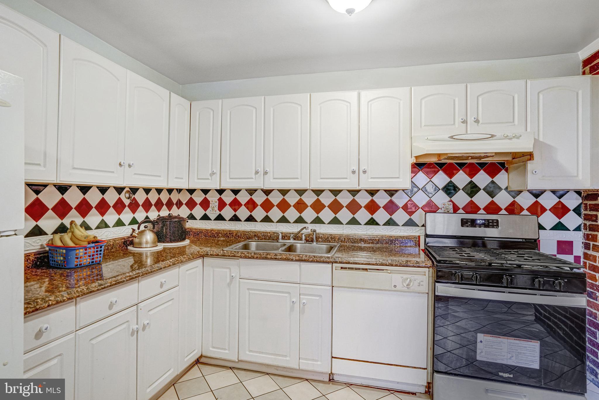 102 South Glebe Road Arlington, VA 22204 - Photo 17 of 52 a kitchen with granite countertop white cabinets and stainless steel appliances
