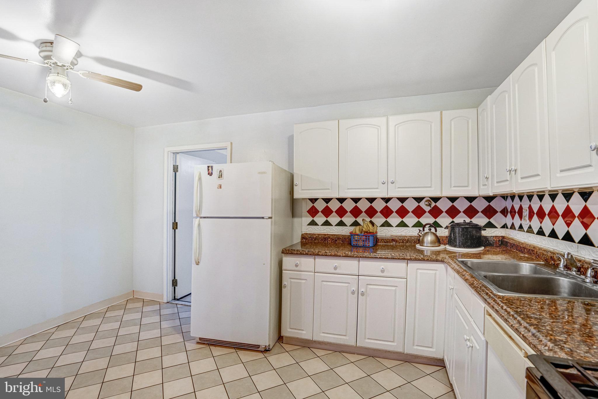 102 South Glebe Road Arlington, VA 22204 - Photo 19 of 52 a kitchen with granite countertop a sink and a refrigerator