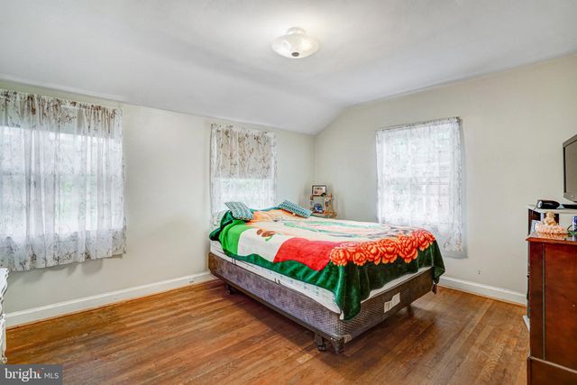 a bedroom with a bed and a dresser in it