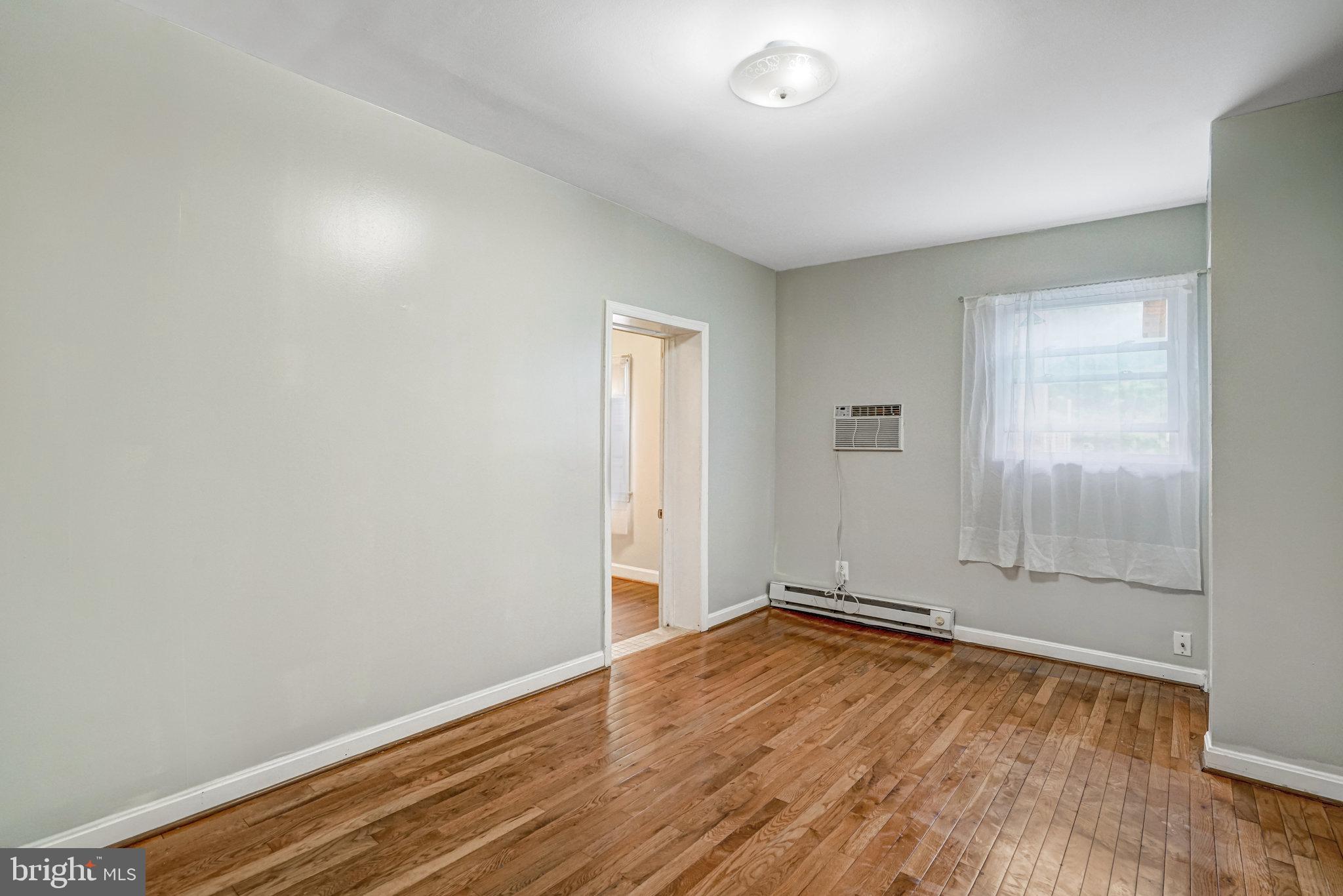 102 South Glebe Road Arlington, VA 22204 - Photo 35 of 52 an empty room with wooden floor and windows