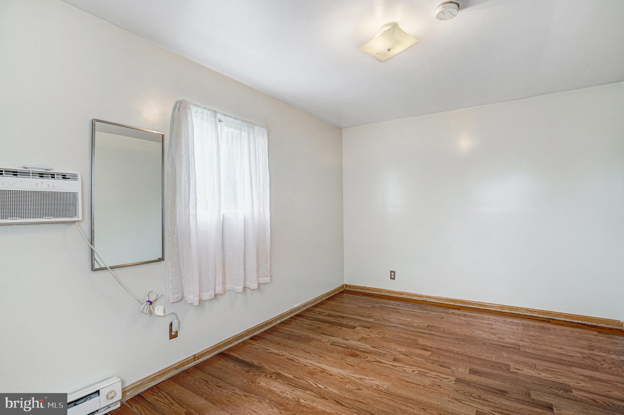 102 South Glebe Road Arlington, VA 22204 - Photo 38 of 52 a view of an empty room with wooden floor and a window
