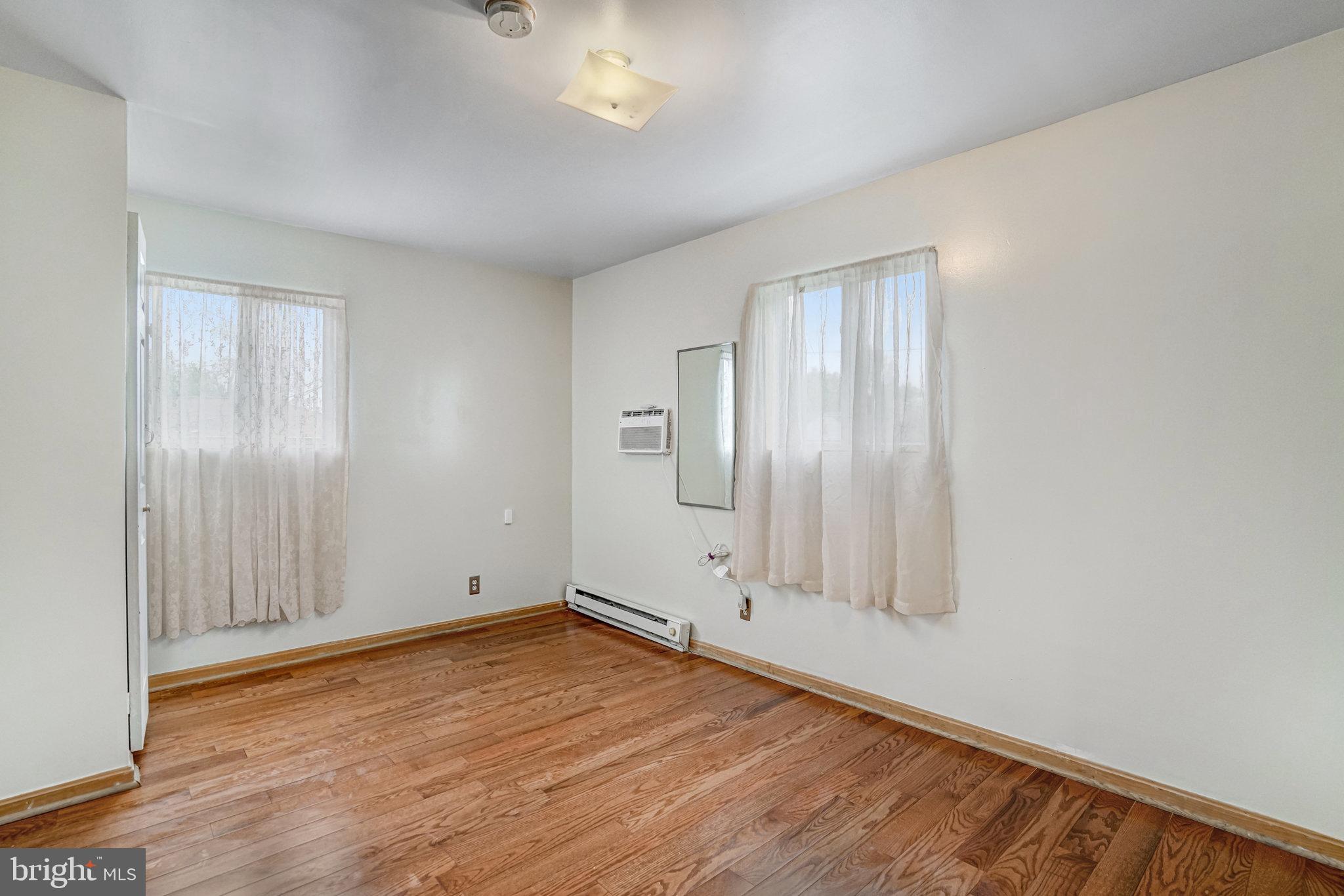 102 South Glebe Road Arlington, VA 22204 - Photo 39 of 52 an empty room with wooden floor and windows