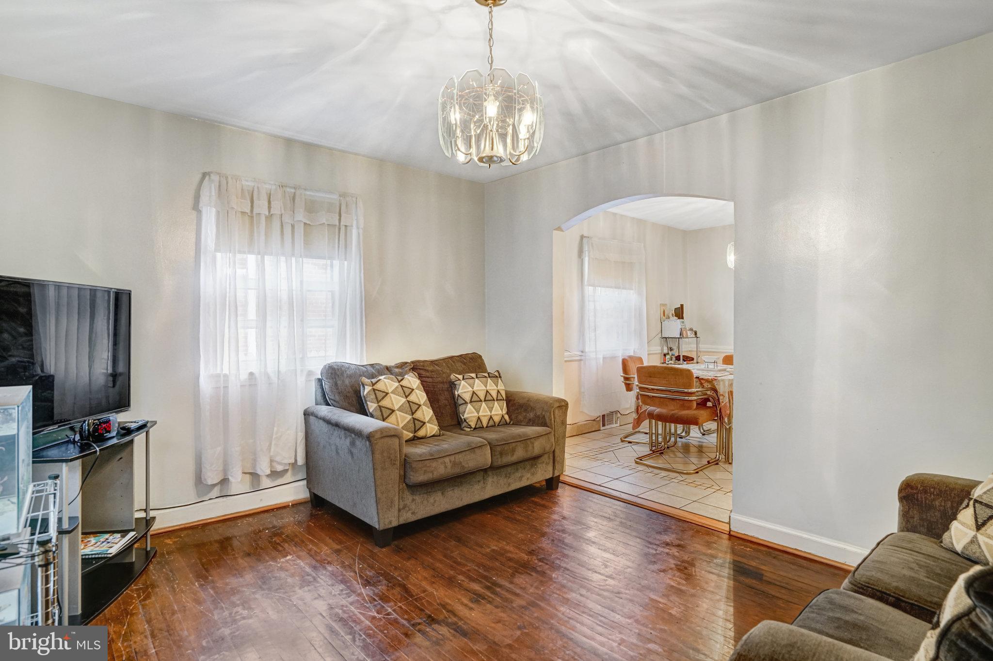 102 South Glebe Road Arlington, VA 22204 - Photo 8 of 52 a living room with furniture and a chandelier