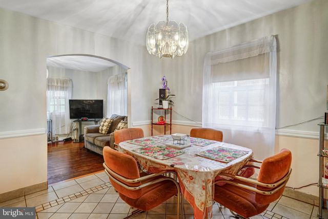a dining room with a table chairs and chandelier