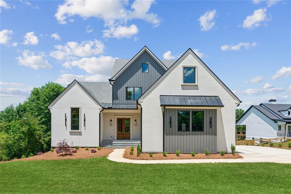 a front view of house with yard and green space