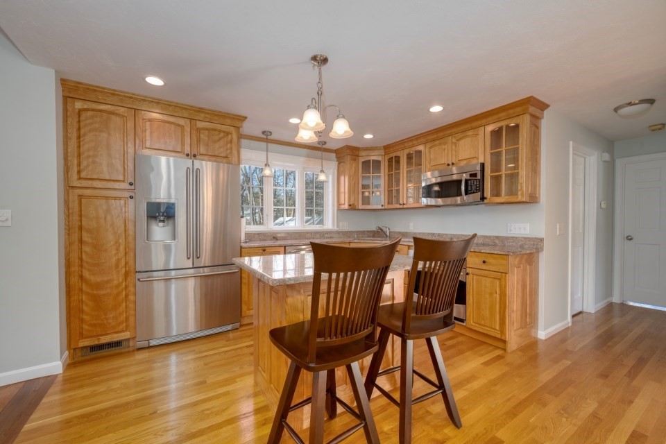 21 Strawberry Lane Whitman, MA 02382 - Photo 13 of 39 a kitchen with stainless steel appliances granite countertop a refrigerator and a stove top oven