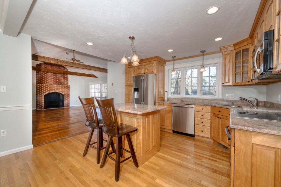 21 Strawberry Lane Whitman, MA 02382 - Photo 16 of 39 a kitchen with stainless steel appliances granite countertop a kitchen island hardwood floor sink stove dining table and chairs