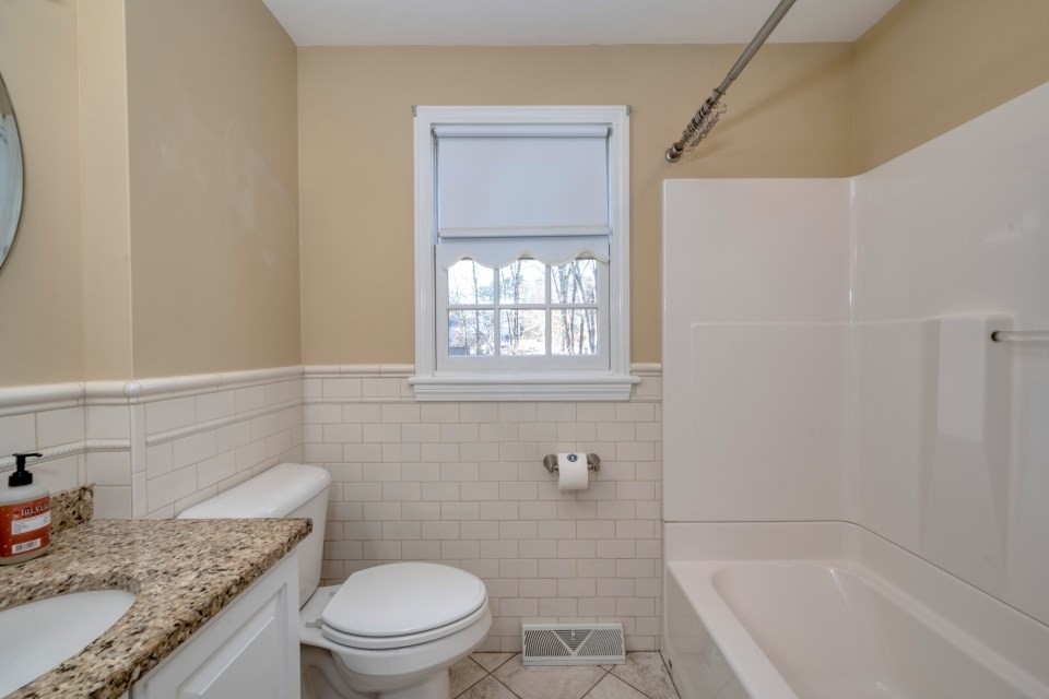 21 Strawberry Lane Whitman, MA 02382 - Photo 21 of 39 a bathroom with a granite countertop toilet a sink and a bathtub