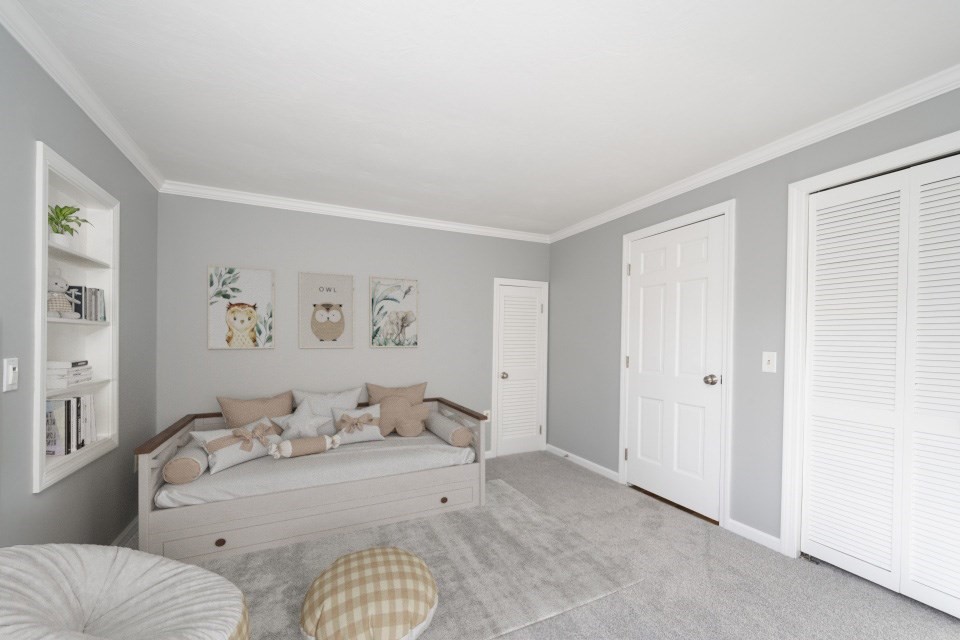 21 Strawberry Lane Whitman, MA 02382 - Photo 25 of 39 a spacious bedroom with a bed and a couch