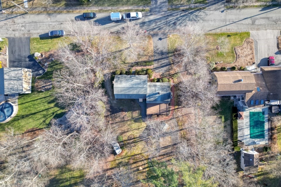 21 Strawberry Lane Whitman, MA 02382 - Photo 33 of 39 a pathway of a house with a yard and wooden fence