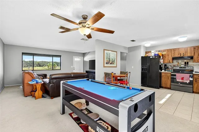 a room with furniture and pool table