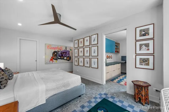 a workstation with a desk chair and painting on the wall