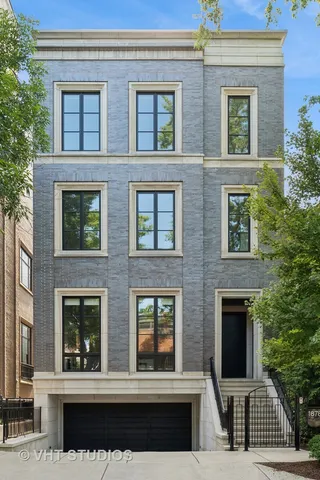 a living room with furniture fireplace and a large window