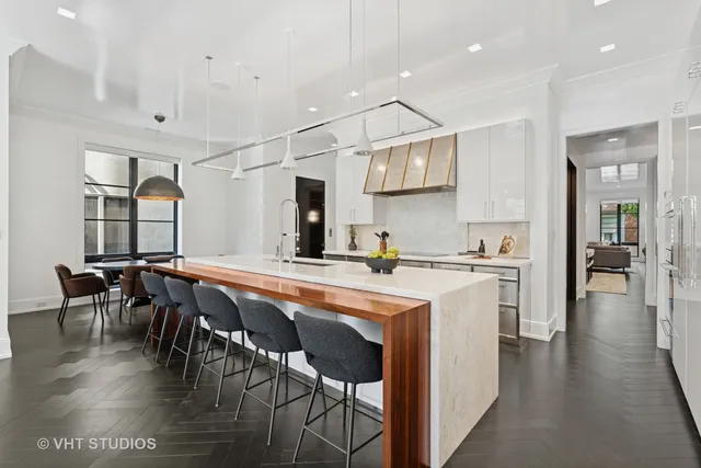 a kitchen with stainless steel appliances granite countertop a sink a stove and a refrigerator