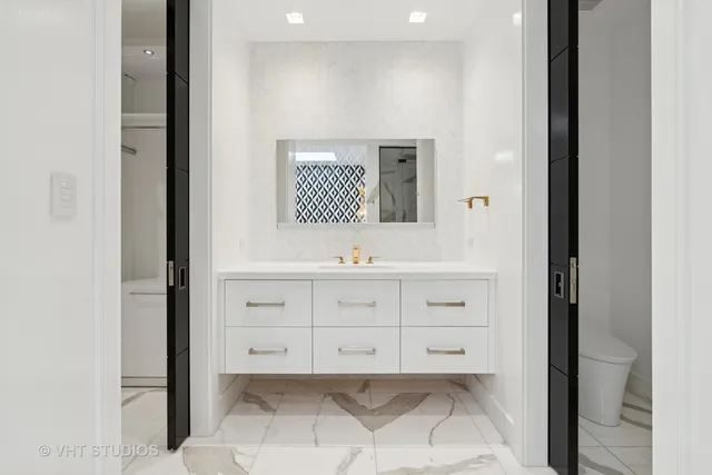 a bathroom with a sink toilet and mirror