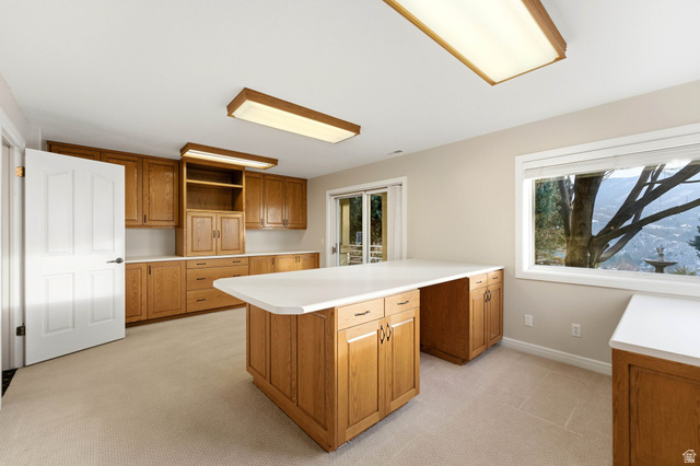 1878 East Ridge Point Drive Bountiful, UT 84010 - Photo 59 of 92 Kitchen featuring wood finish cabinetry, light colored carpet, light countertops, a peninsula, and open shelves