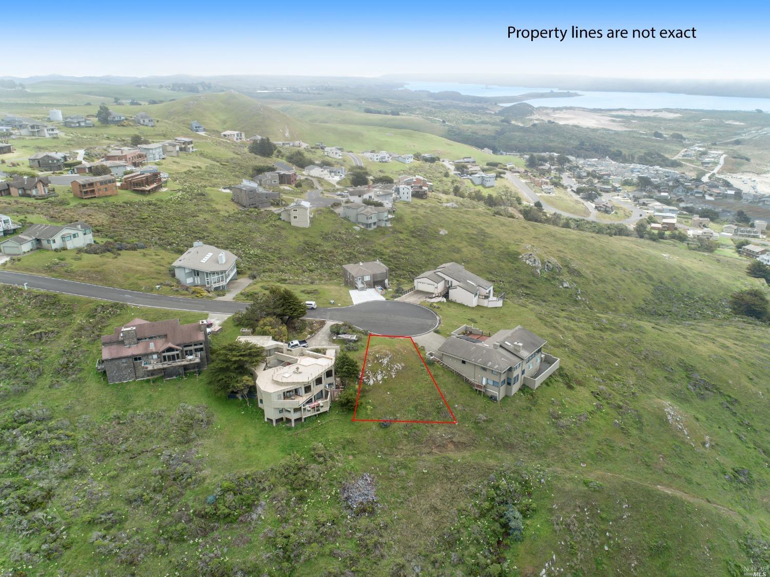 an aerial view of a house with a ocean view