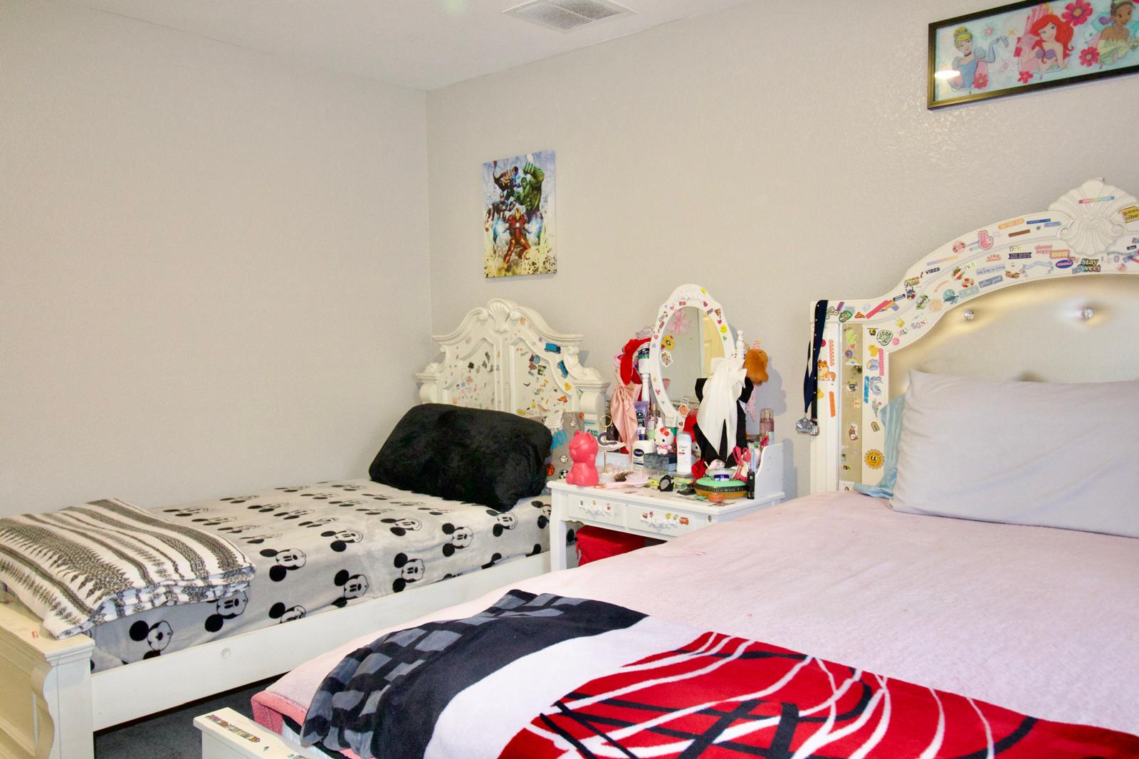 2545 Four Waters Loop Georgetown, TX 78628 - Photo 8 of 14 Smooth walls and carpeted flooring define this versatile secondary bedroom space.