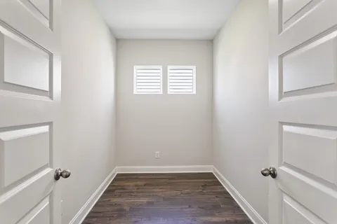a view of a room with a wooden floor and a window
