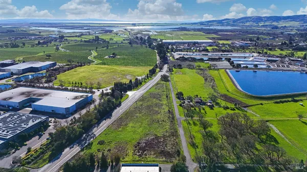 an aerial view of a house with a garden and swimming pool