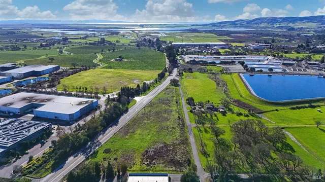 an aerial view of a house with a garden and swimming pool
