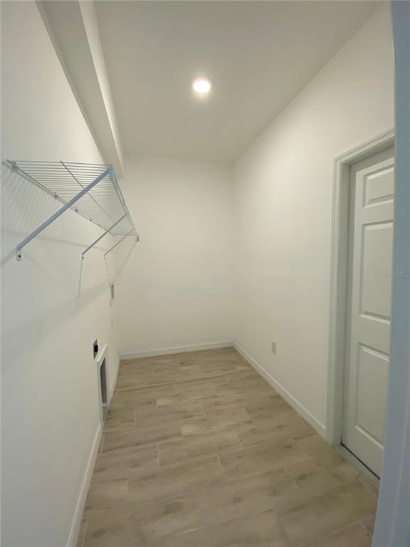 13216 Keystone Boulevard, Unit 13216 Port Charlotte, FL 33981 - Photo 12 of 23 wooden floor in an empty room with a bathroom