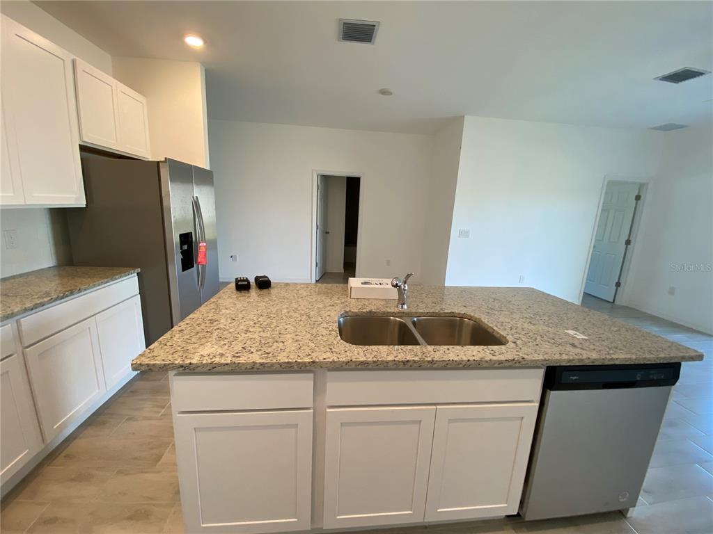 13216 Keystone Boulevard, Unit 13216 Port Charlotte, FL 33981 - Photo 17 of 23 a bathroom with a granite countertop sink and a mirror