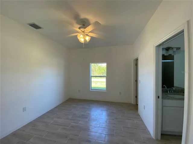 an empty room with windows and closet