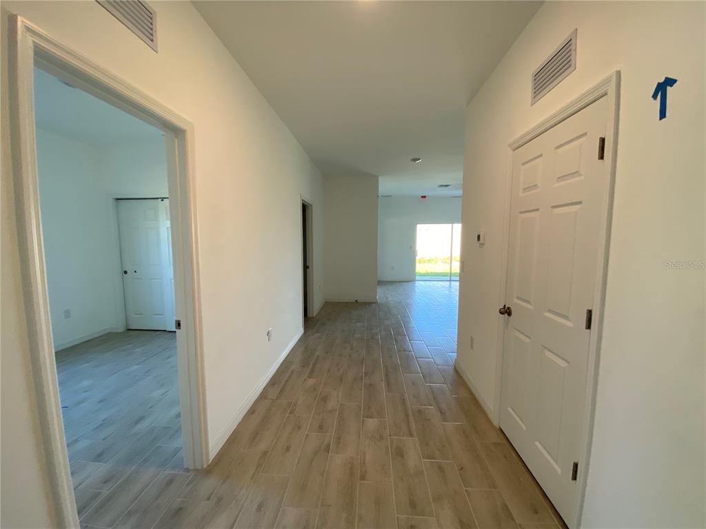 13216 Keystone Boulevard, Unit 13216 Port Charlotte, FL 33981 - Photo 4 of 23 a view of hallway with wooden floor