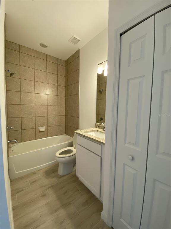 13216 Keystone Boulevard, Unit 13216 Port Charlotte, FL 33981 - Photo 6 of 23 a bathroom with a granite countertop bathtub shower sink vanity and toilet