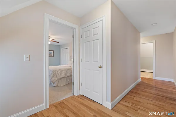 a spacious bedroom with a bed and a ceiling fan