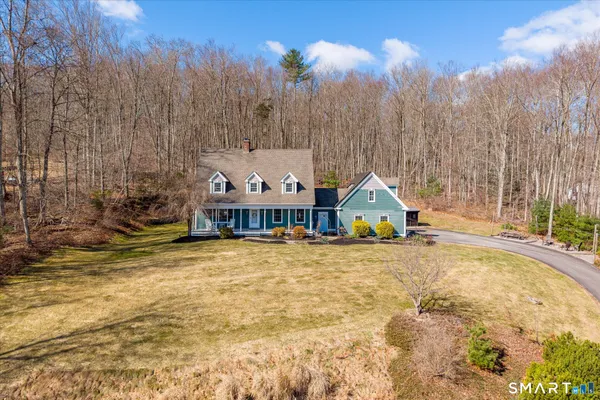 a view of large house with a big yard and large trees