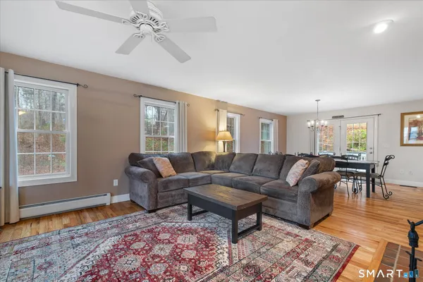 a living room with furniture and a wooden floor