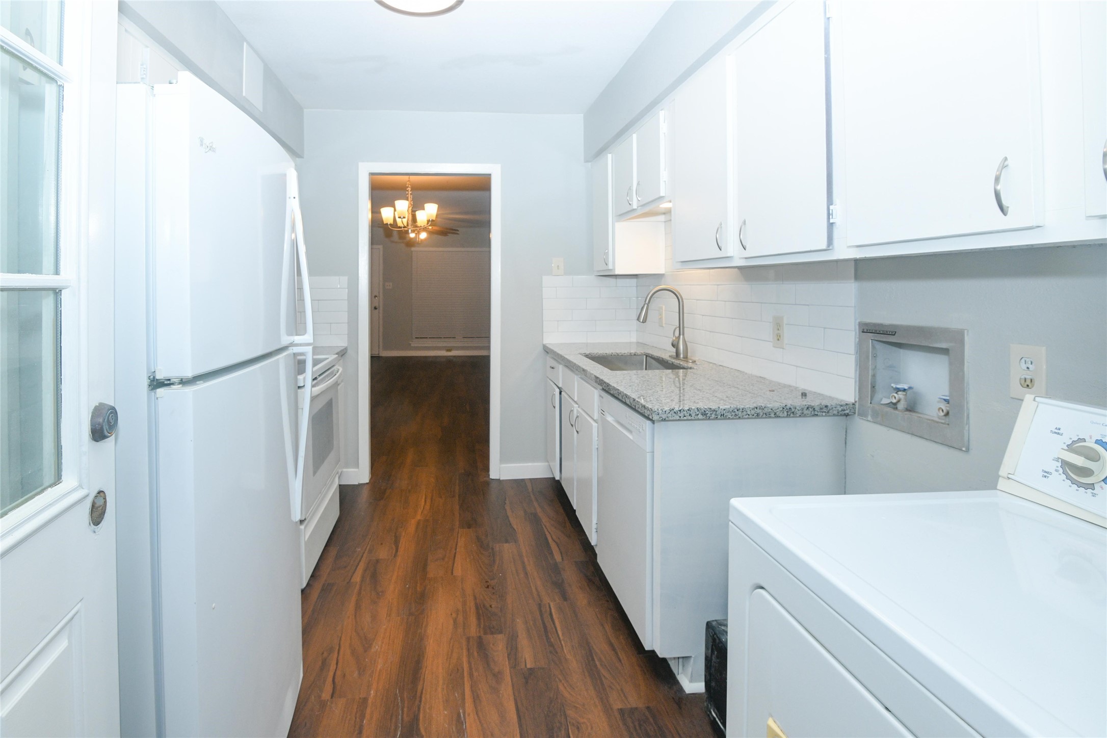 2675 Gessner Road, Unit 103 Houston, TX 77080 - Photo 6 of 13 a kitchen with a sink a refrigerator and cabinets