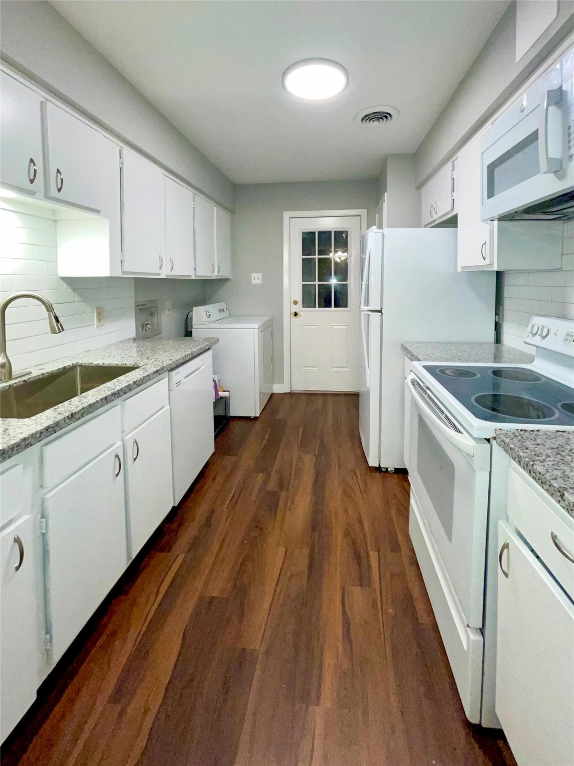 2675 Gessner Road, Unit 103 Houston, TX 77080 - Photo 7 of 13 a kitchen with cabinets a sink and wooden floor