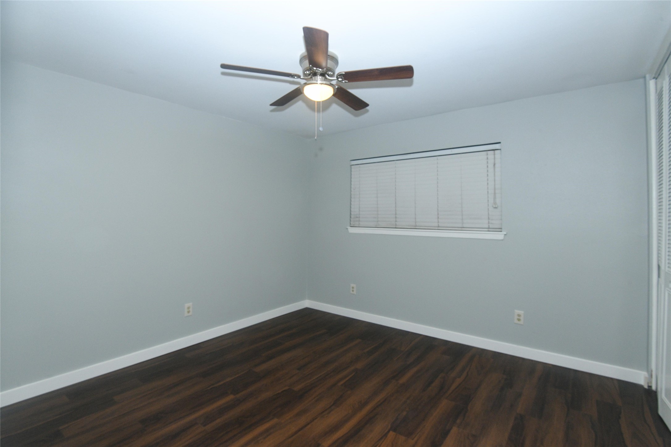 2675 Gessner Road, Unit 103 Houston, TX 77080 - Photo 9 of 13 a view of wooden floor and a chandelier fan in a room